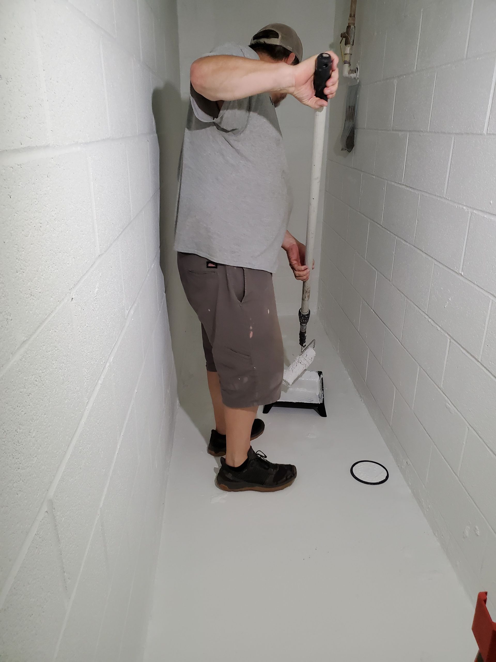 a man is standing in a hallway holding a cane