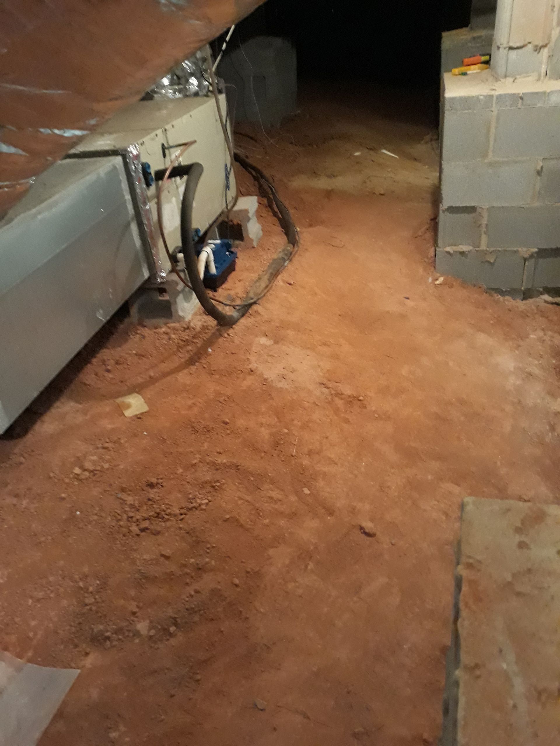 a basement with a lot of dirt and a hose coming out of it