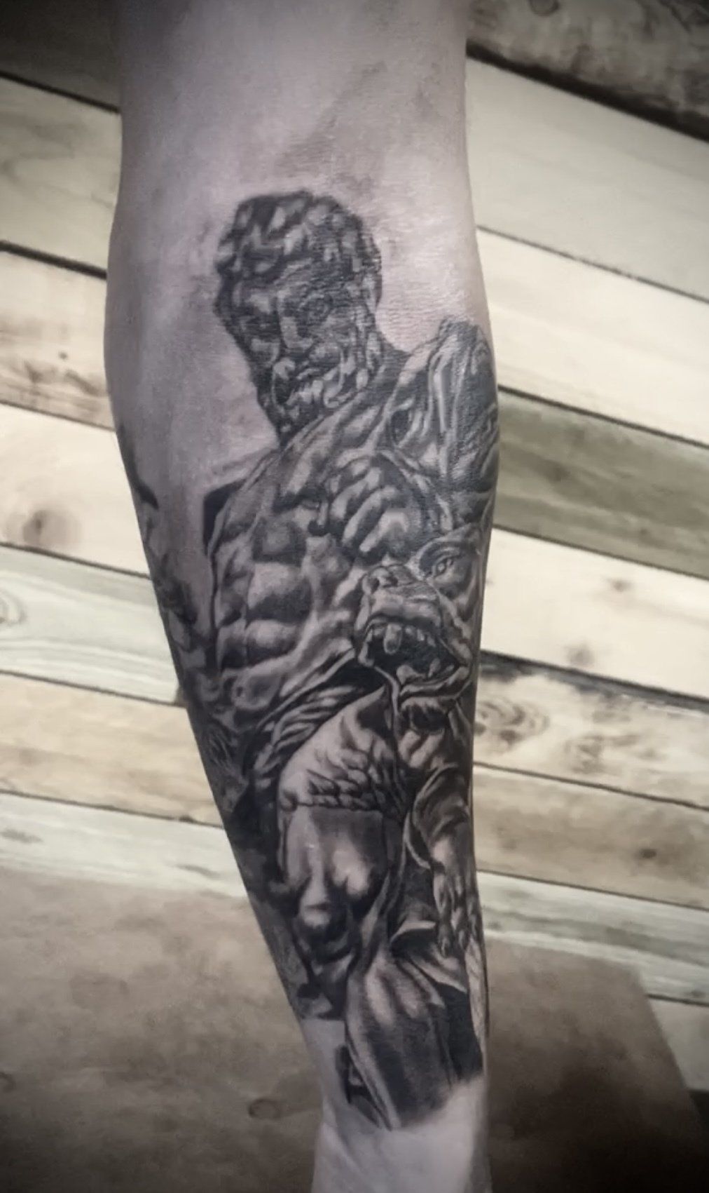 A black and white tattoo of a mummy on a person 's leg.