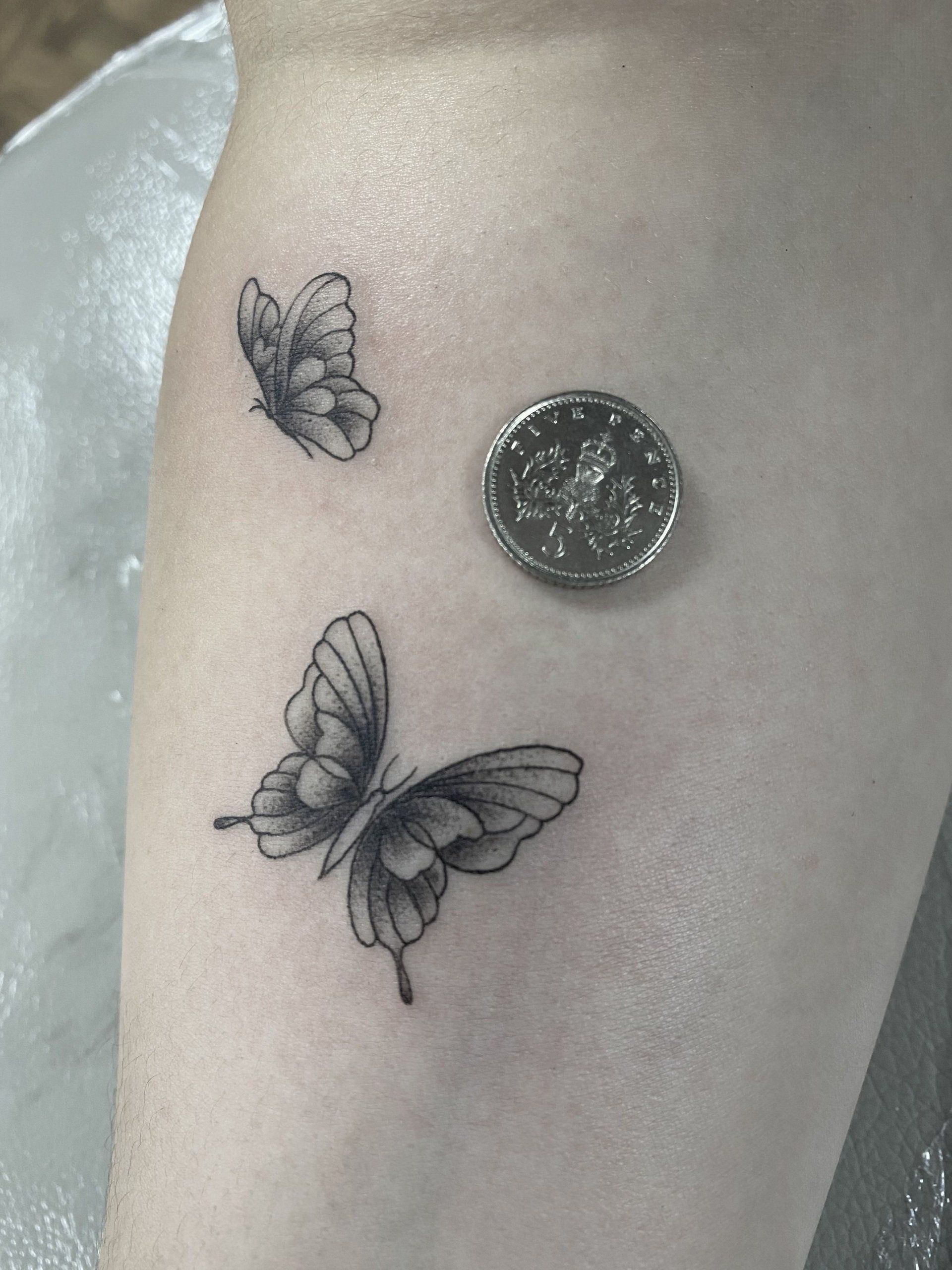 Fine linework butterflies tattoo