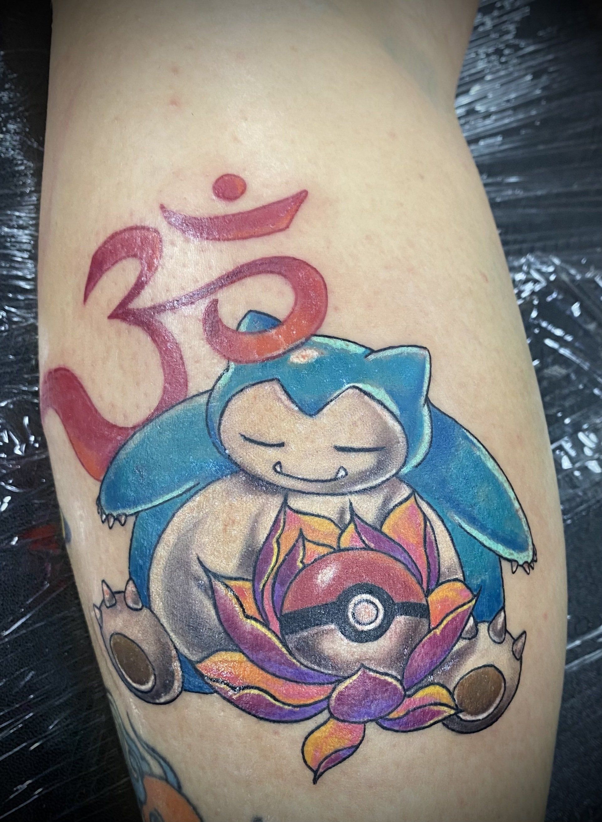 A person has a snorlax tattoo on their leg