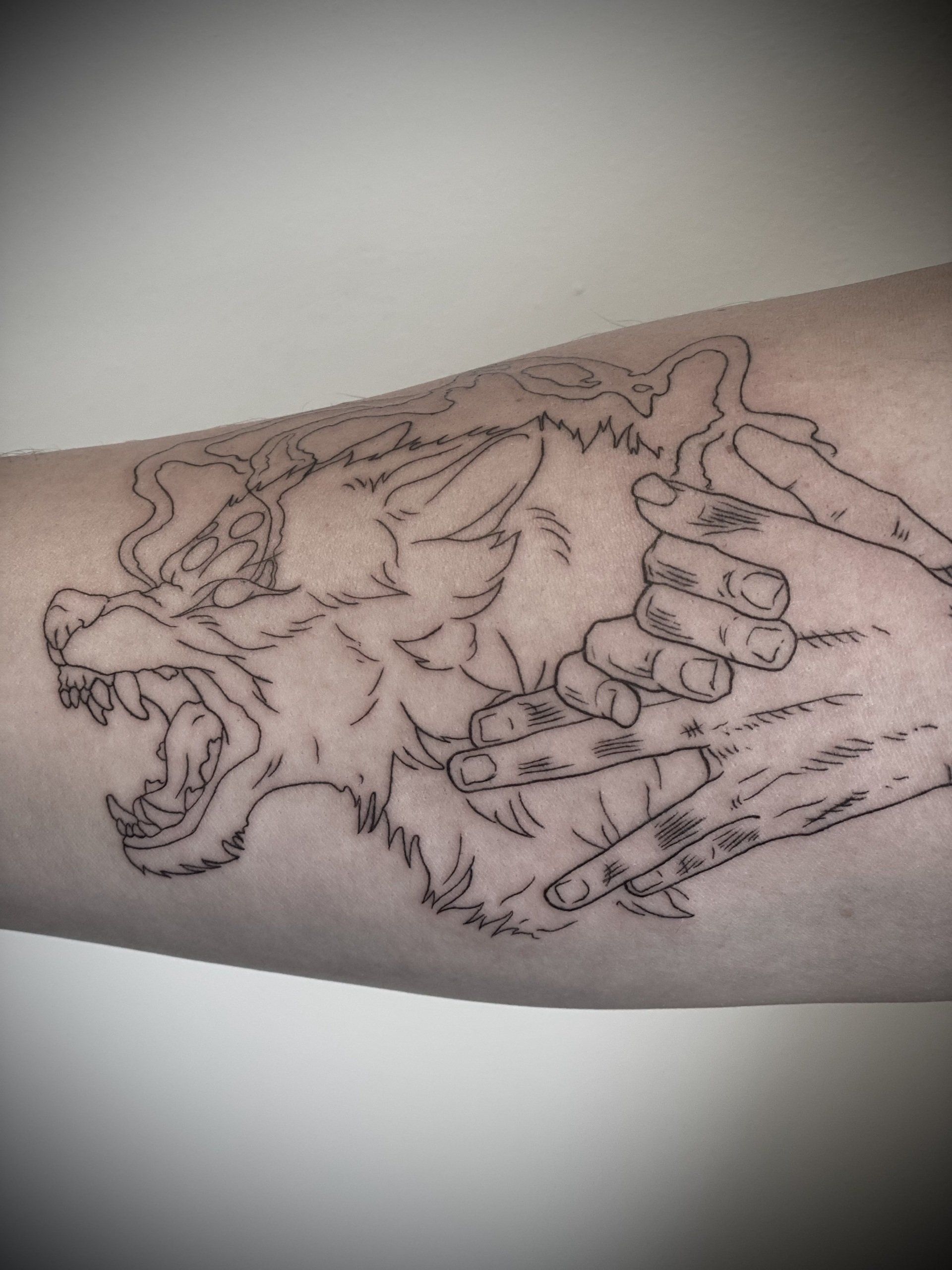 A tattoo of a lion on a person 's arm
