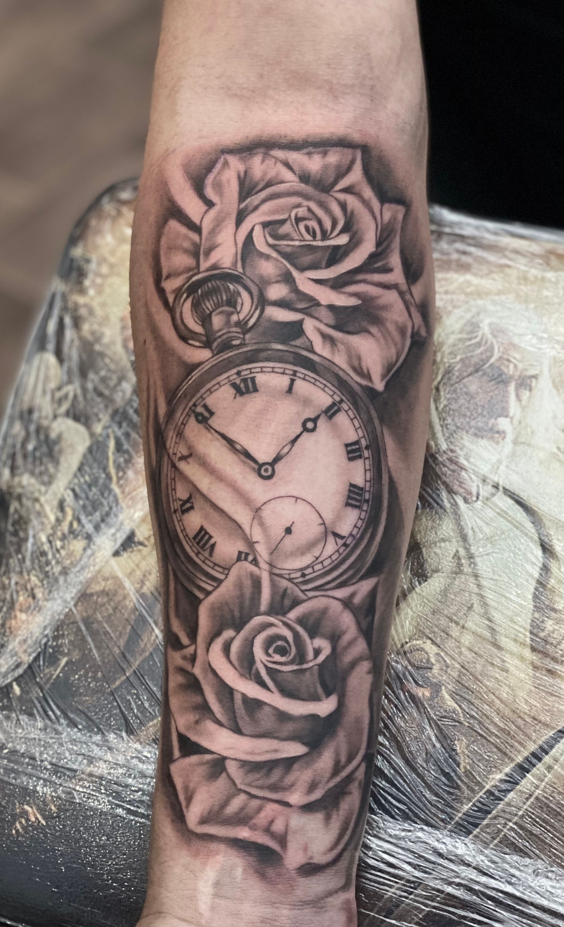 Black and grey roses and watch tattoo