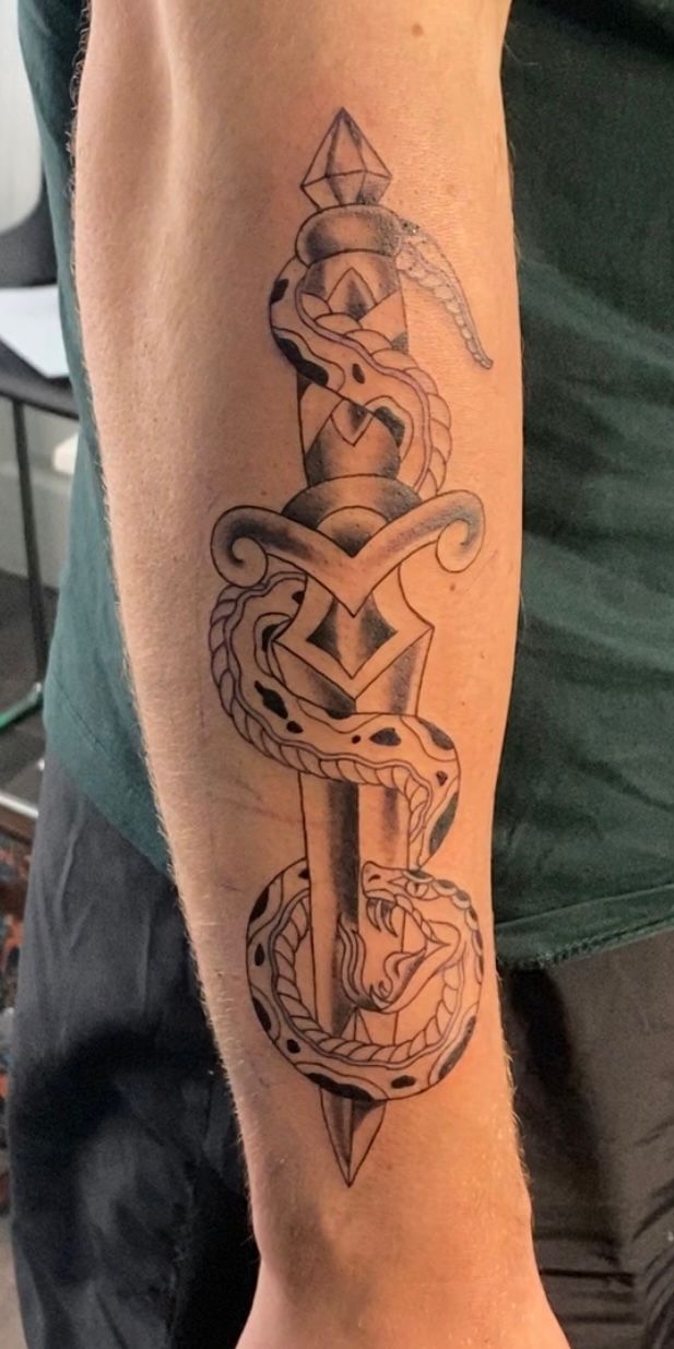 Traditional snake and dagger tattoo