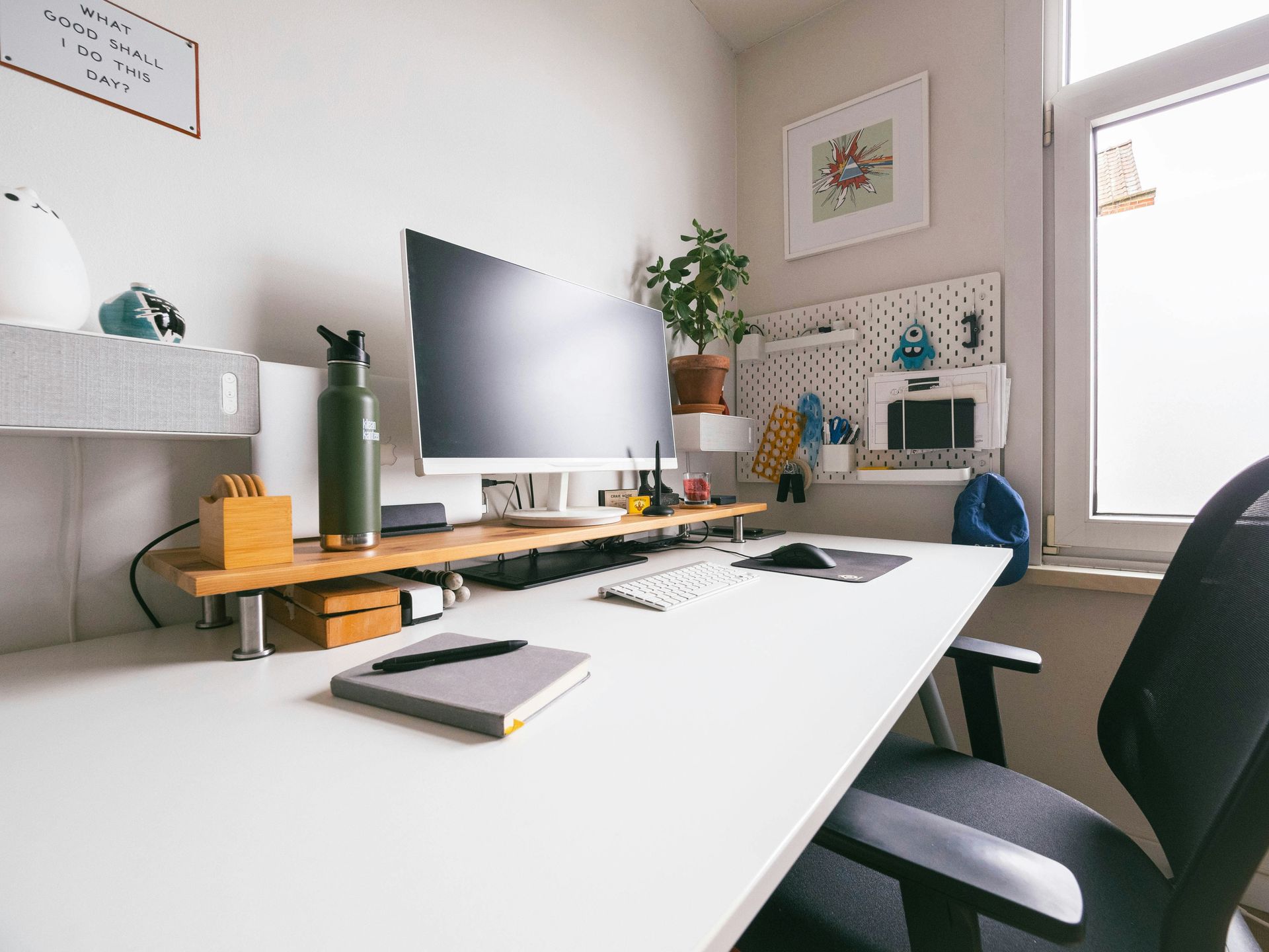 Efficient systems create space for business growth. Organised home office workspace with computer, notebook and desk setup, representing streamlined business operations and productivity.
