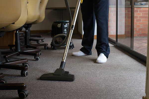 Man Vacuuming the Carpet — Redding, CA — Peerless Building Maintenance