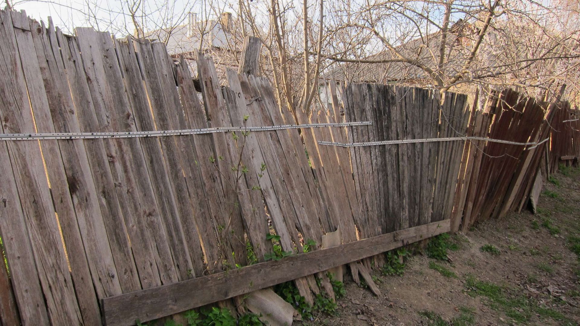 A wooden fence with a barbed wire fence around it