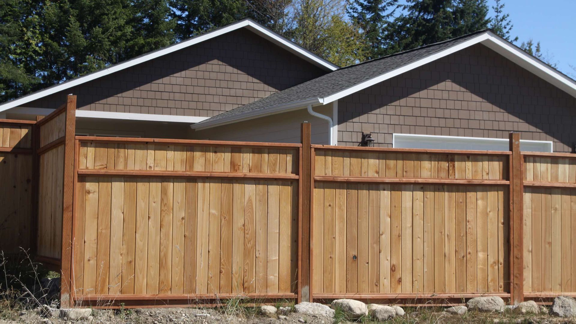 A house with a wooden fence in front of it