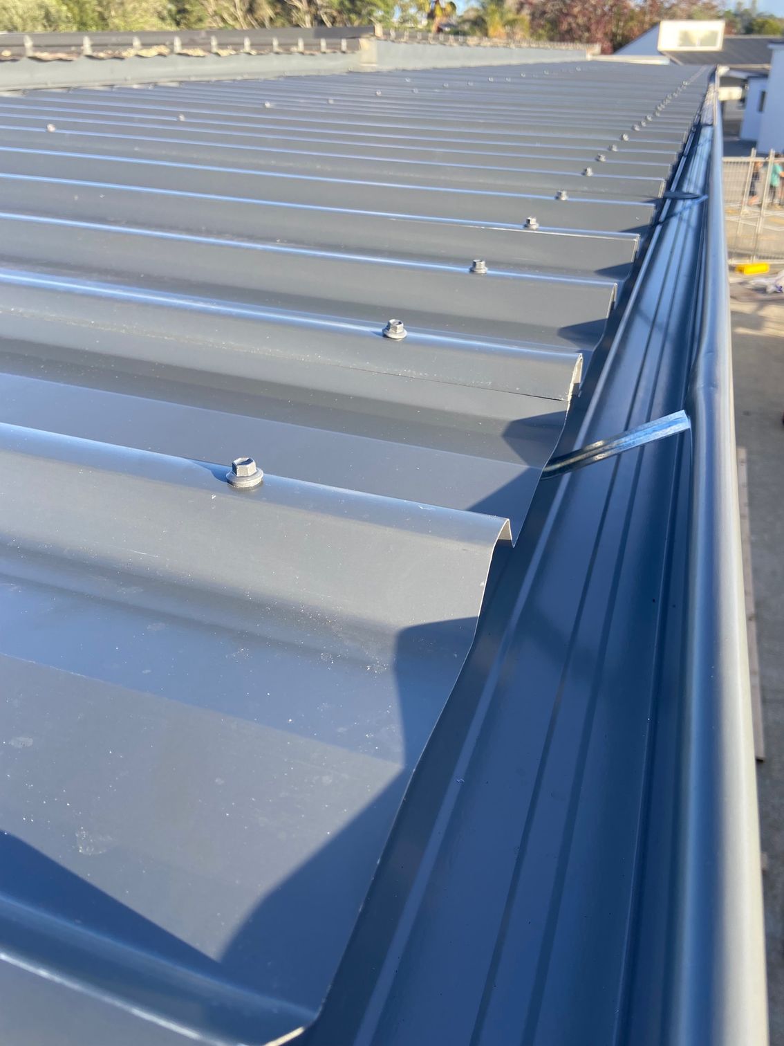 Gray metal roof with a matching gutter.