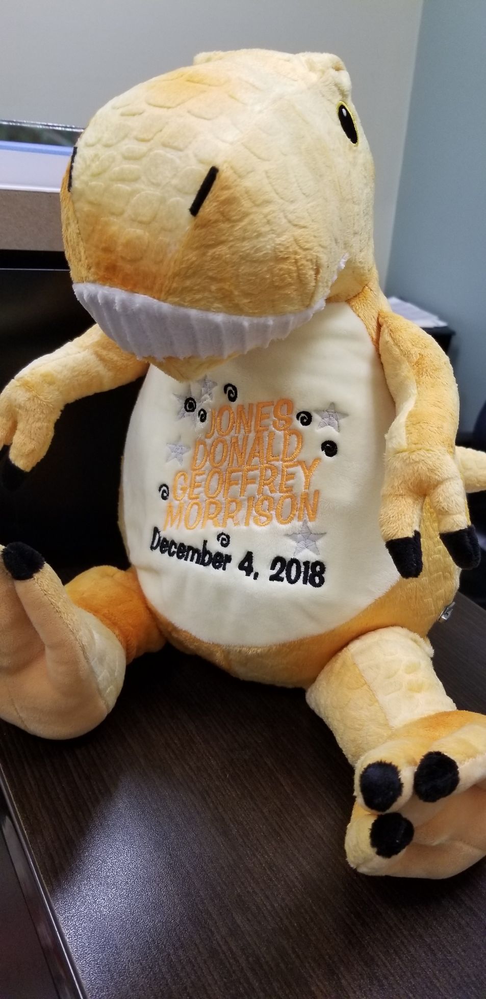 Stuffed yellow Tyrannosaurus Rex with orange belly embroidery 