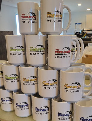 Stack of white mugs with 