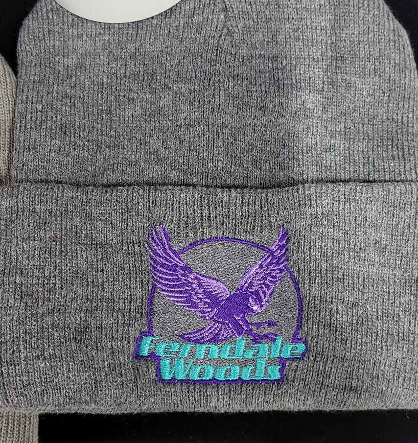 Gray beanie with a purple eagle logo embroidered on it, 