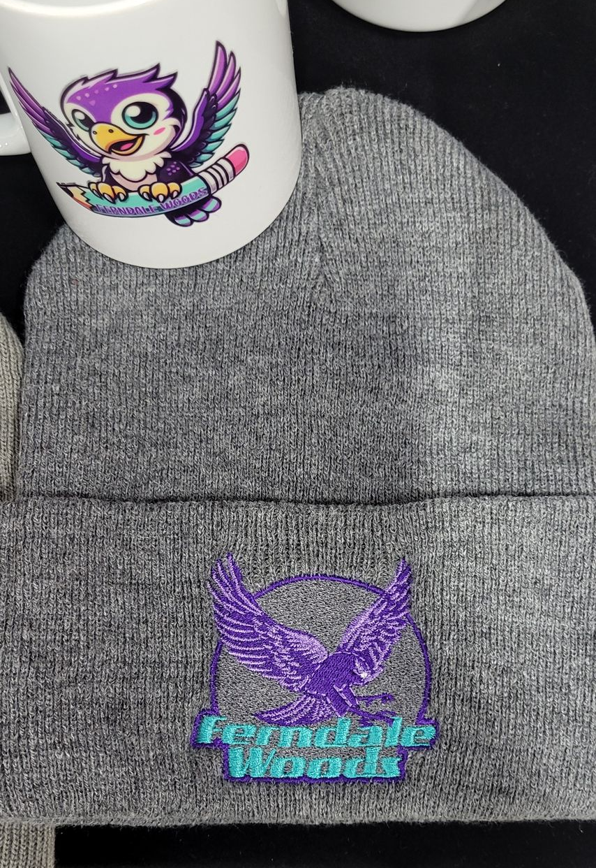 Grey beanie with a purple eagle logo, and a mug with a purple cartoon bird.