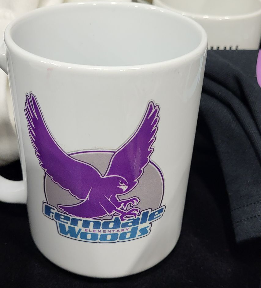 White mug with purple eagle logo for Ferndale Woods Elementary.