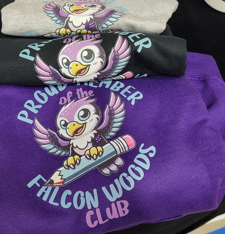 Three folded sweatshirts, featuring a cartoon falcon with a pencil; text reads 
