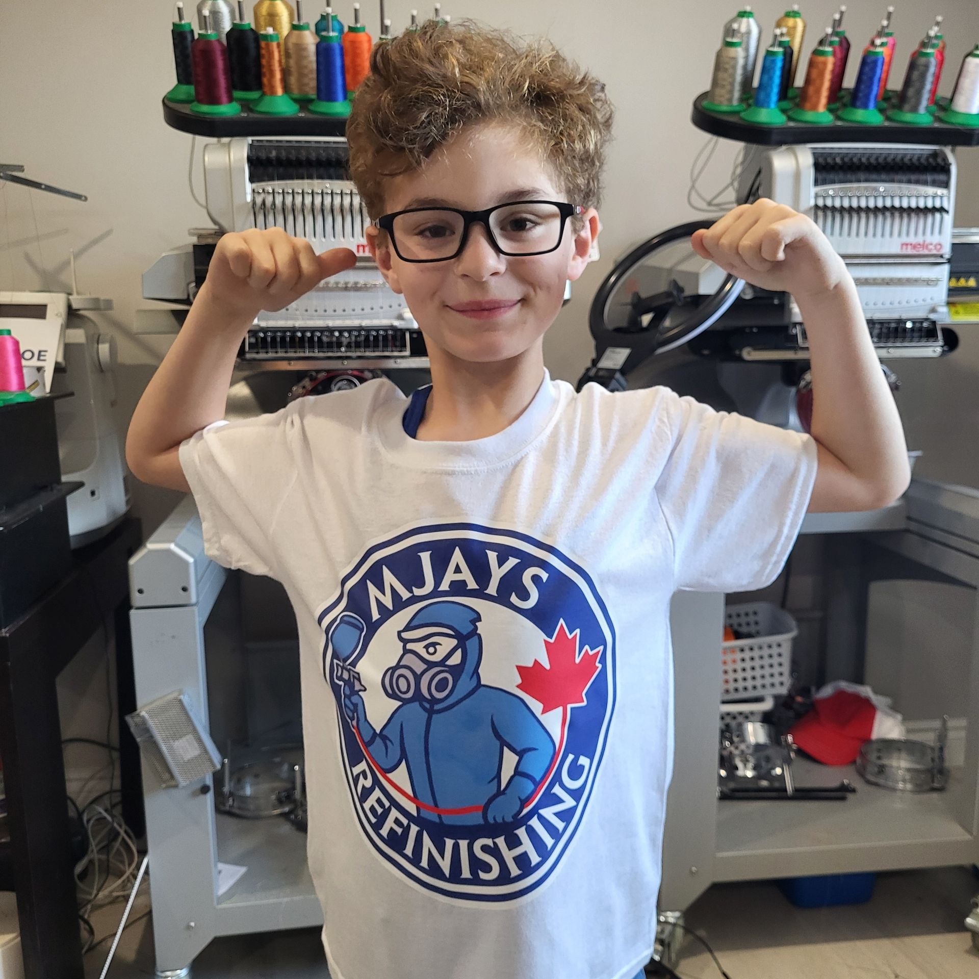 Boy flexing arms, wearing a white