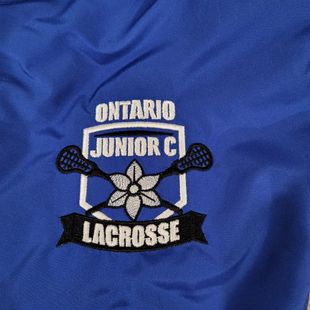 Blue fabric with Ontario Junior C Lacrosse logo, black and white emblem of crossed sticks.