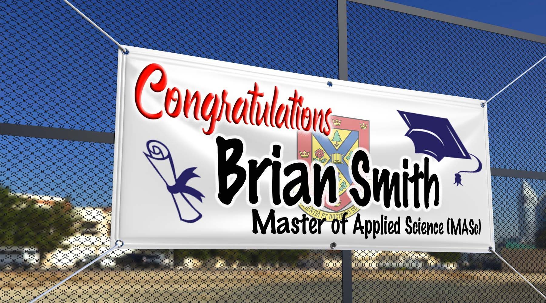 White banner congratulating Brian Smith on his Master of Applied Science degree; hung on a chain-link fence.