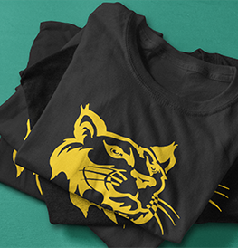 Black t-shirts stacked with a yellow bobcat graphic.
