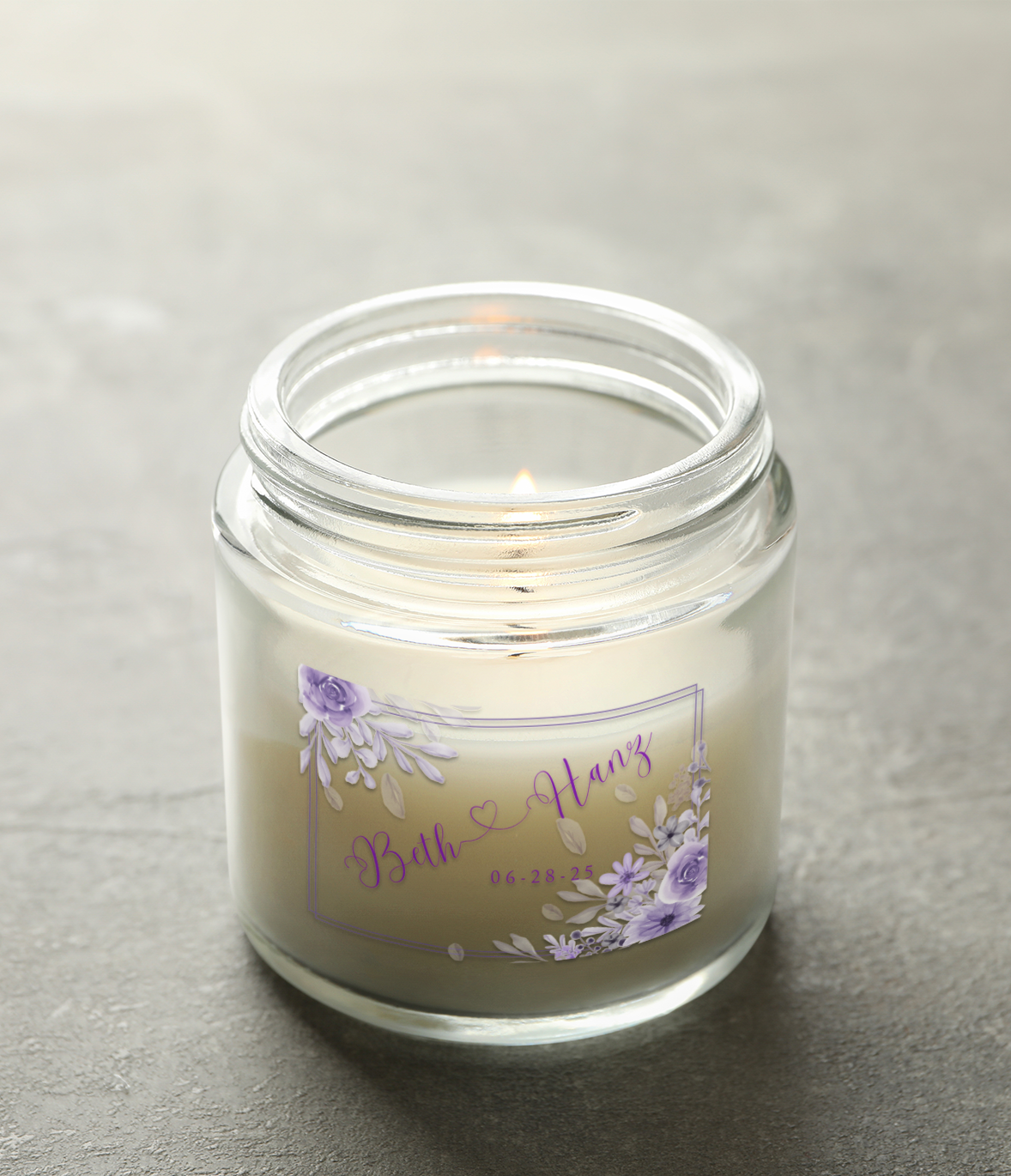 Glass candle with purple floral label; names