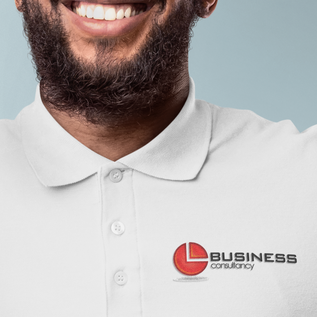Man smiling, wearing white polo shirt with a 