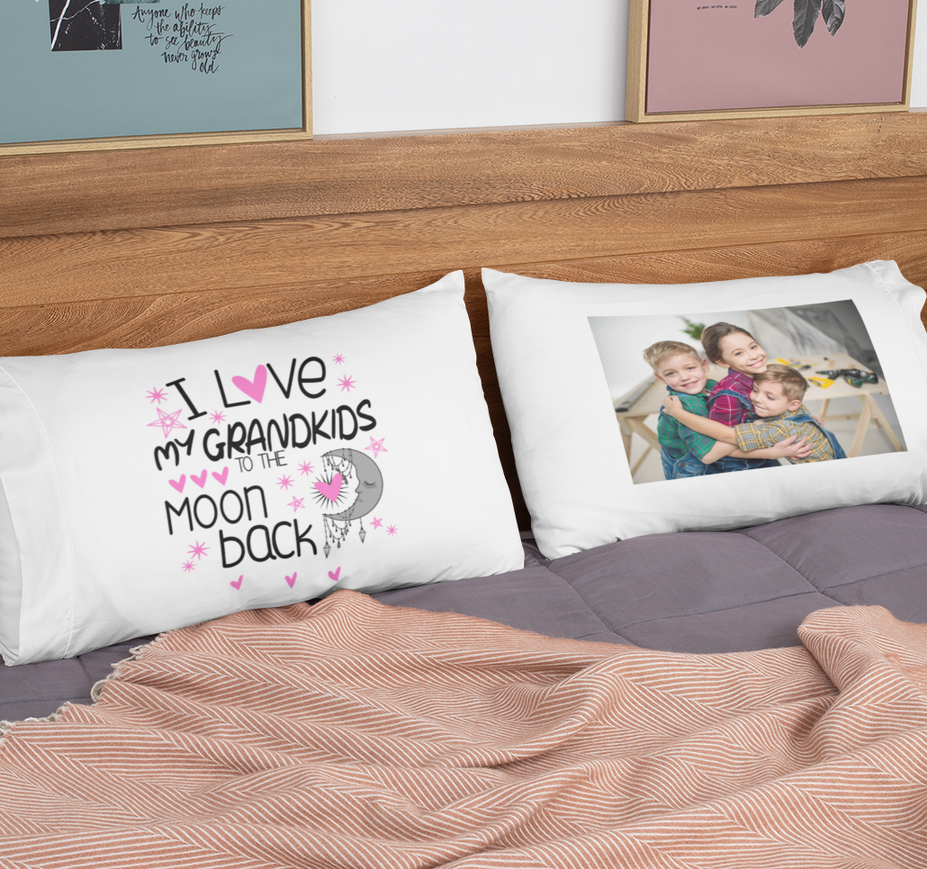 Two white pillows on a bed; one with text,