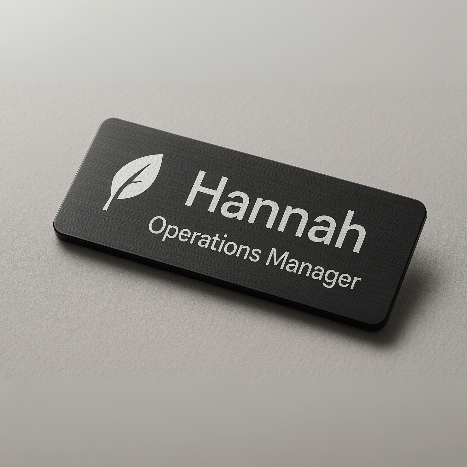 Black name tag with the name 
