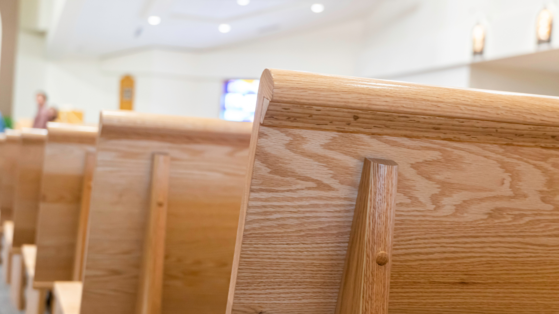 A row of wooden benches in a church.