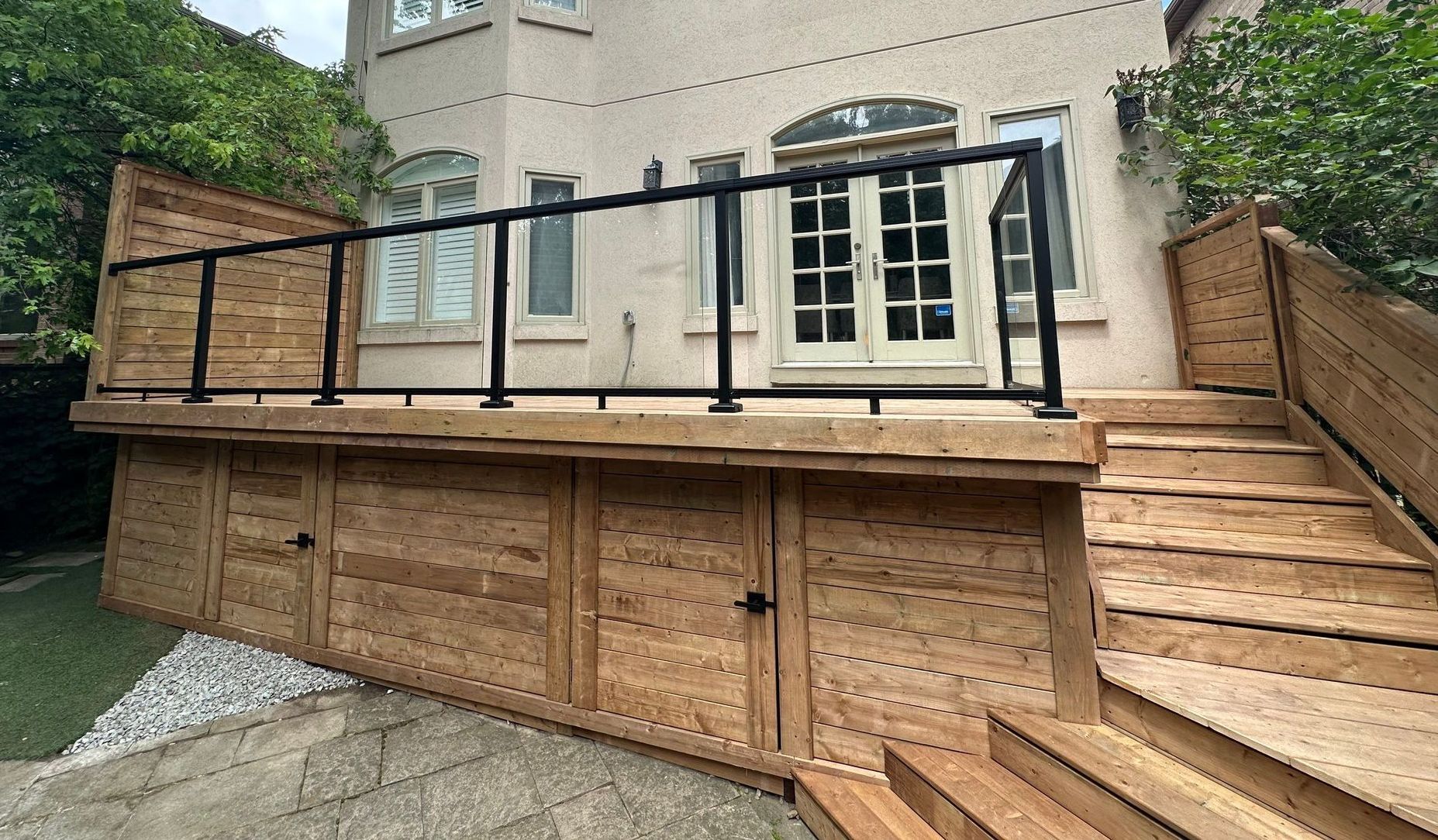 There is a wooden deck with stairs leading up to it.