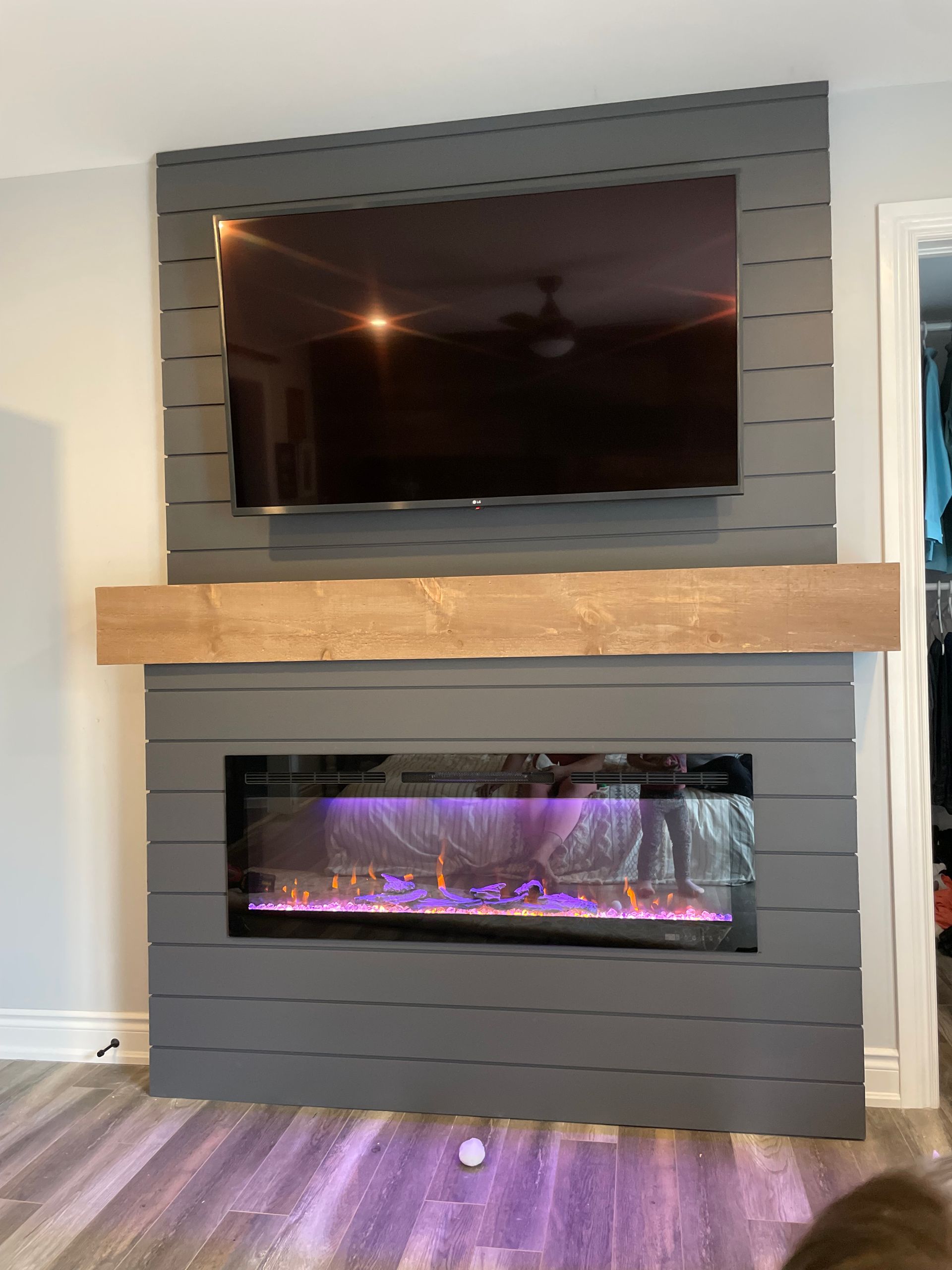 A living room with a fireplace and a flat screen tv.