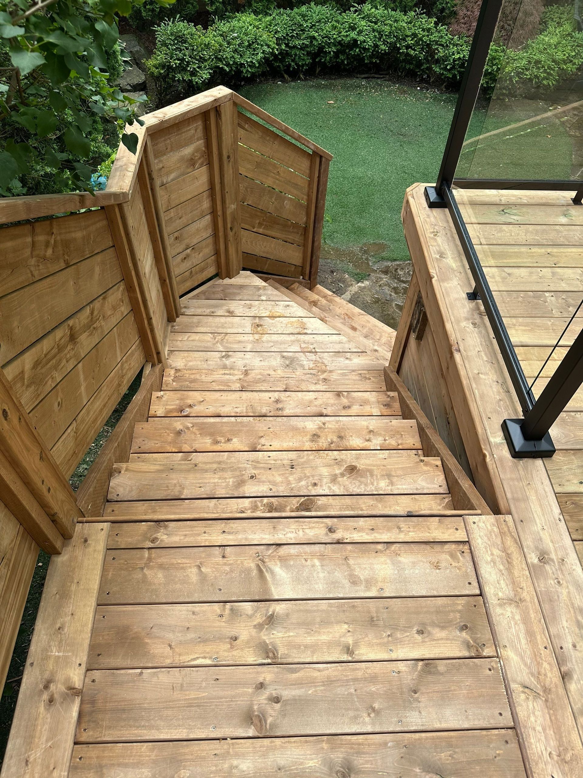 A wooden deck with stairs leading up to it.