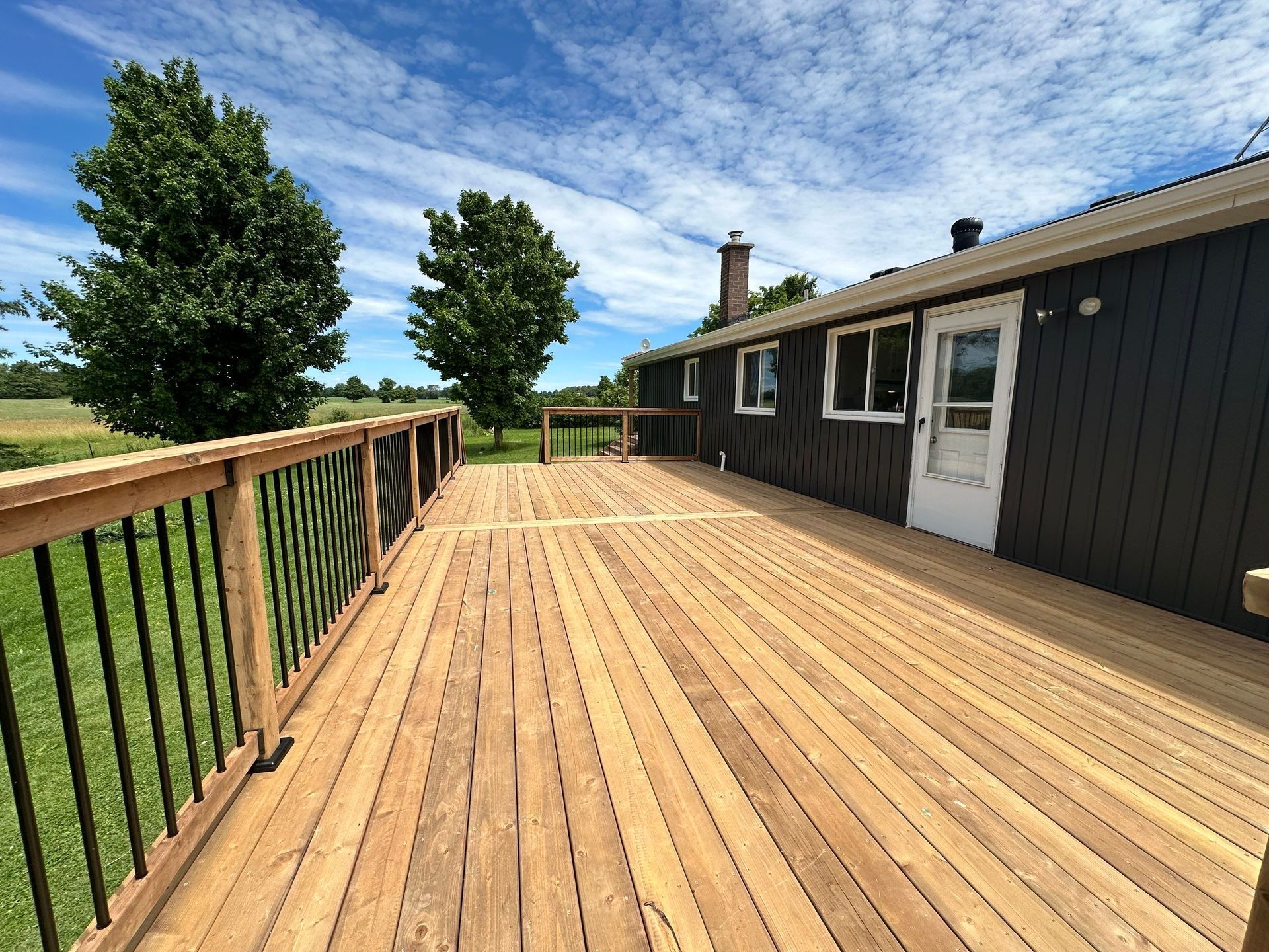 A large wooden deck in front of a house