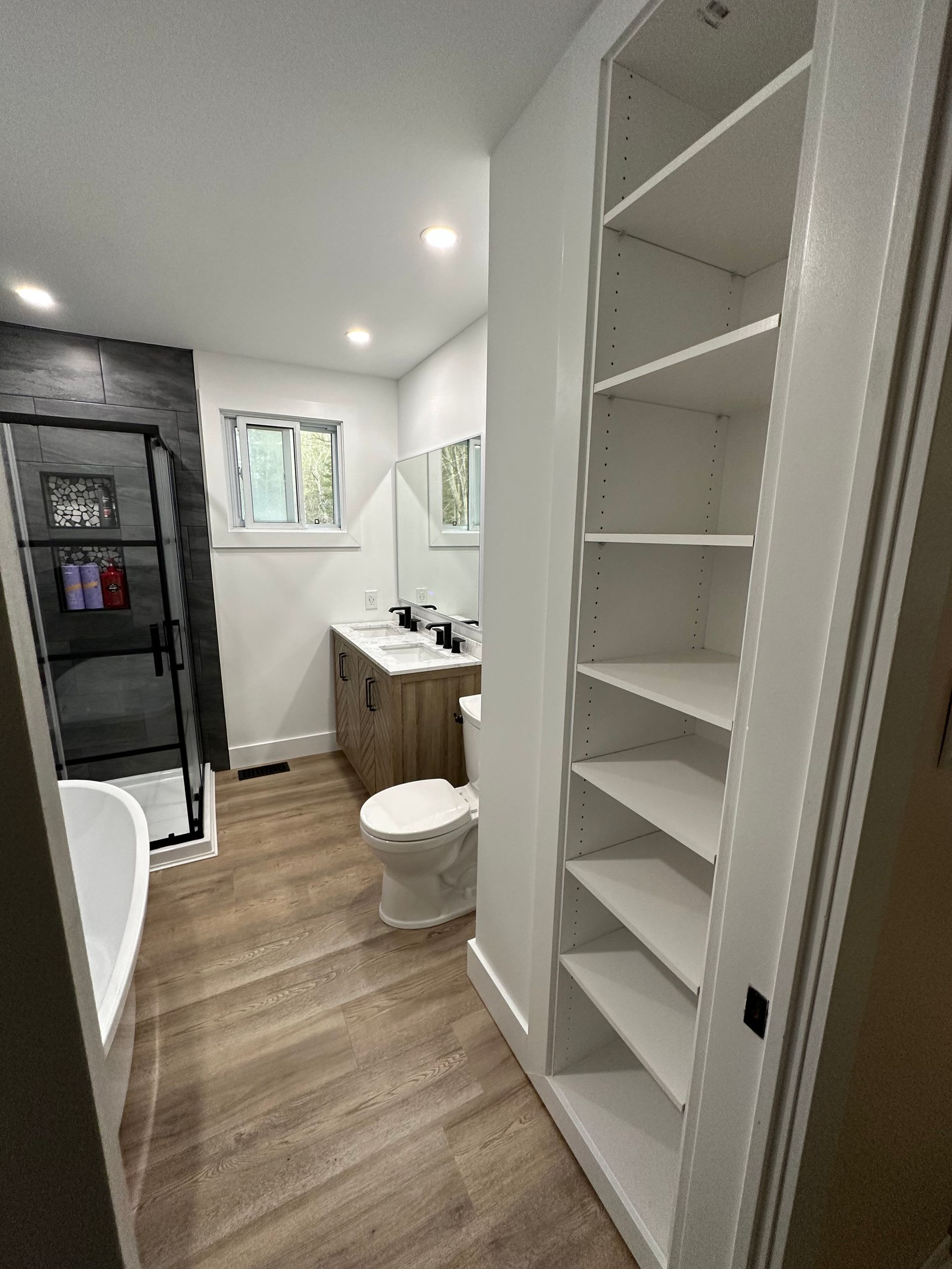 A bathroom with a toilet , sink , and shower.