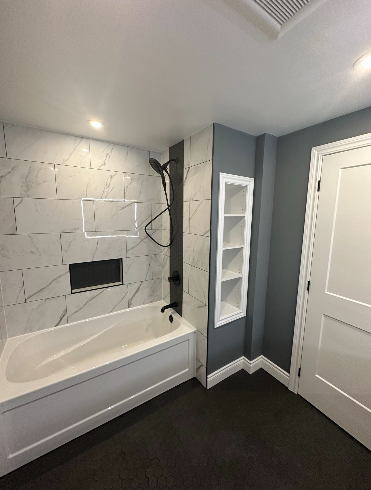 A bathroom with a bathtub and a shower.