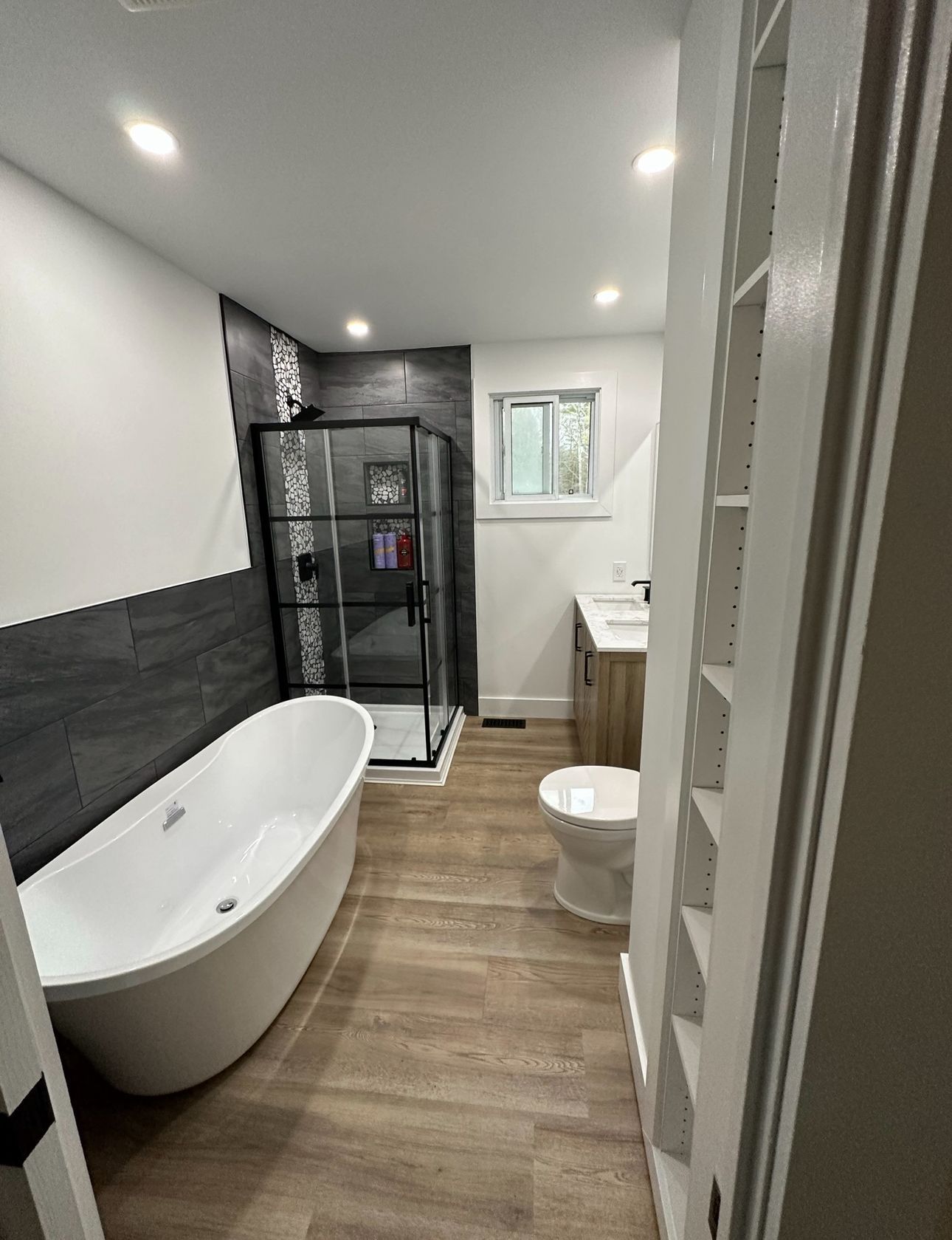 A bathroom with a tub , toilet , sink and shower.