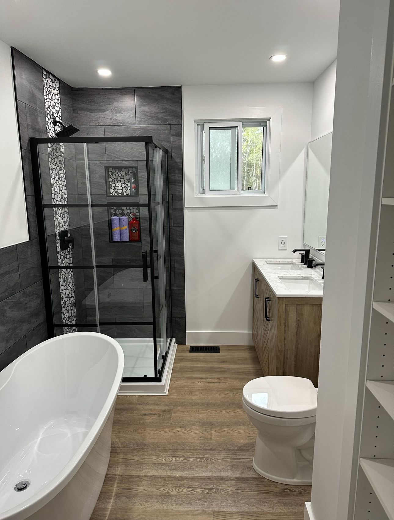 A bathroom with a tub , toilet , sink and shower.