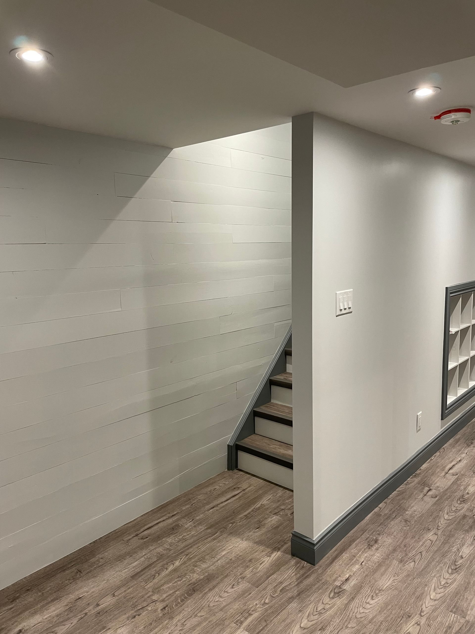 A basement with stairs leading up to the second floor.