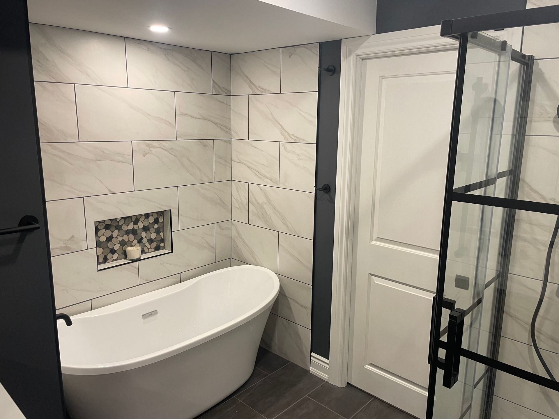 A bathroom with a bathtub and a shower stall.