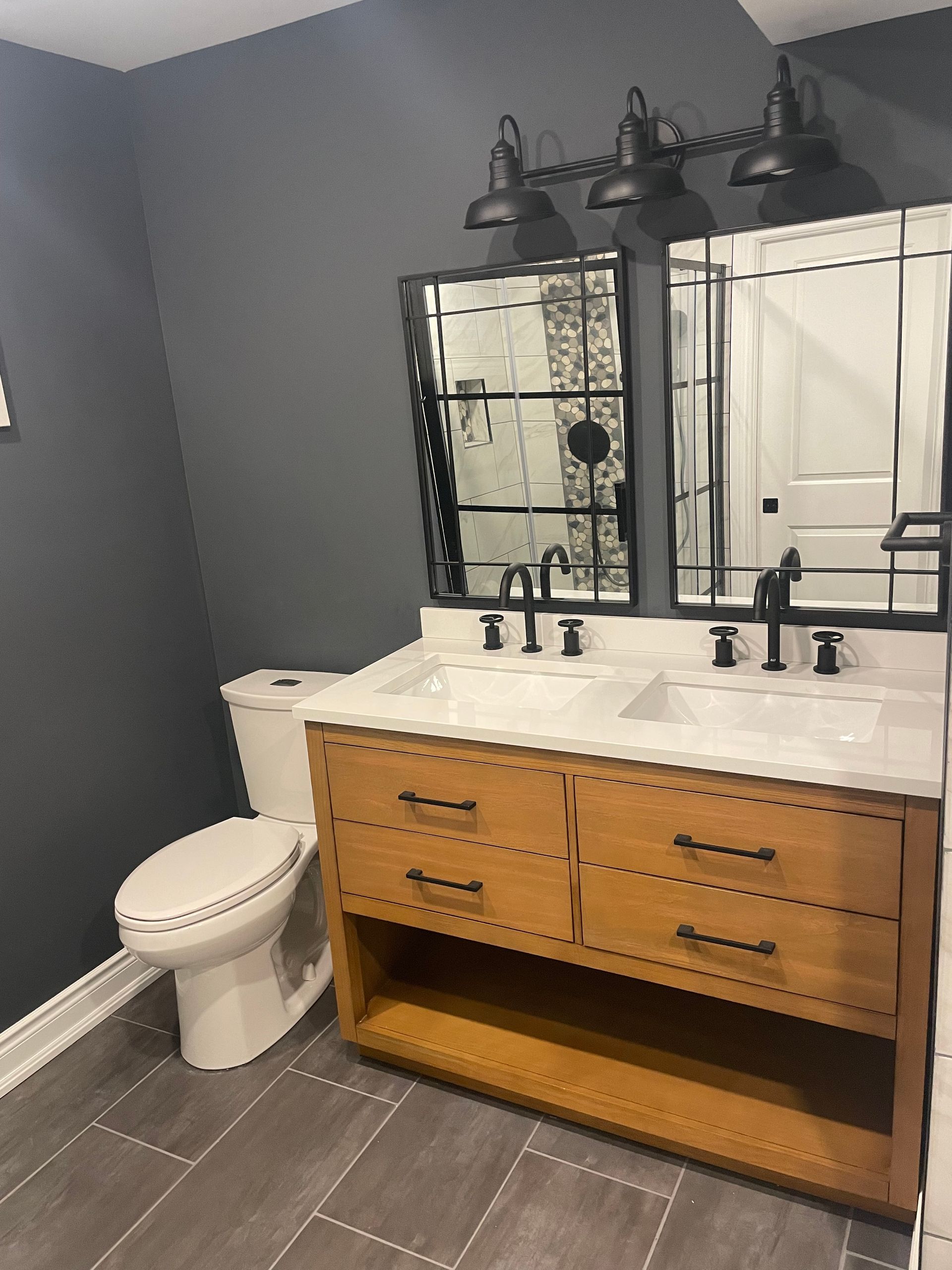 A bathroom with a toilet , sink and mirror
