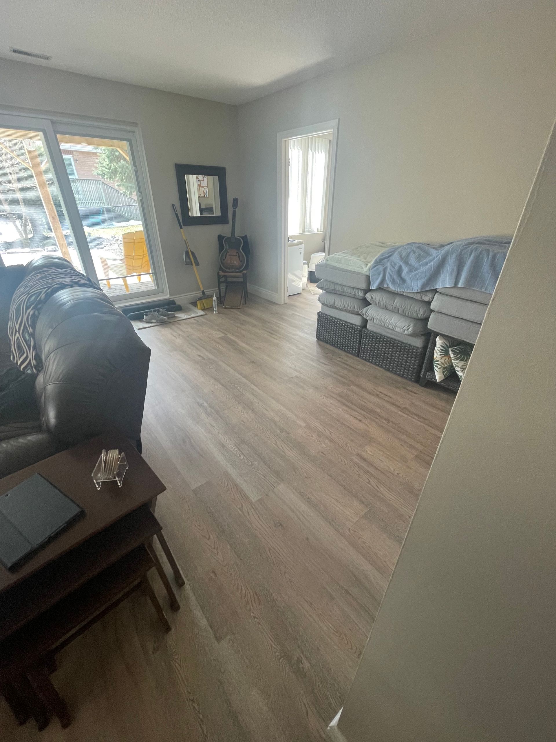 A living room with a couch , coffee table , and a bed.