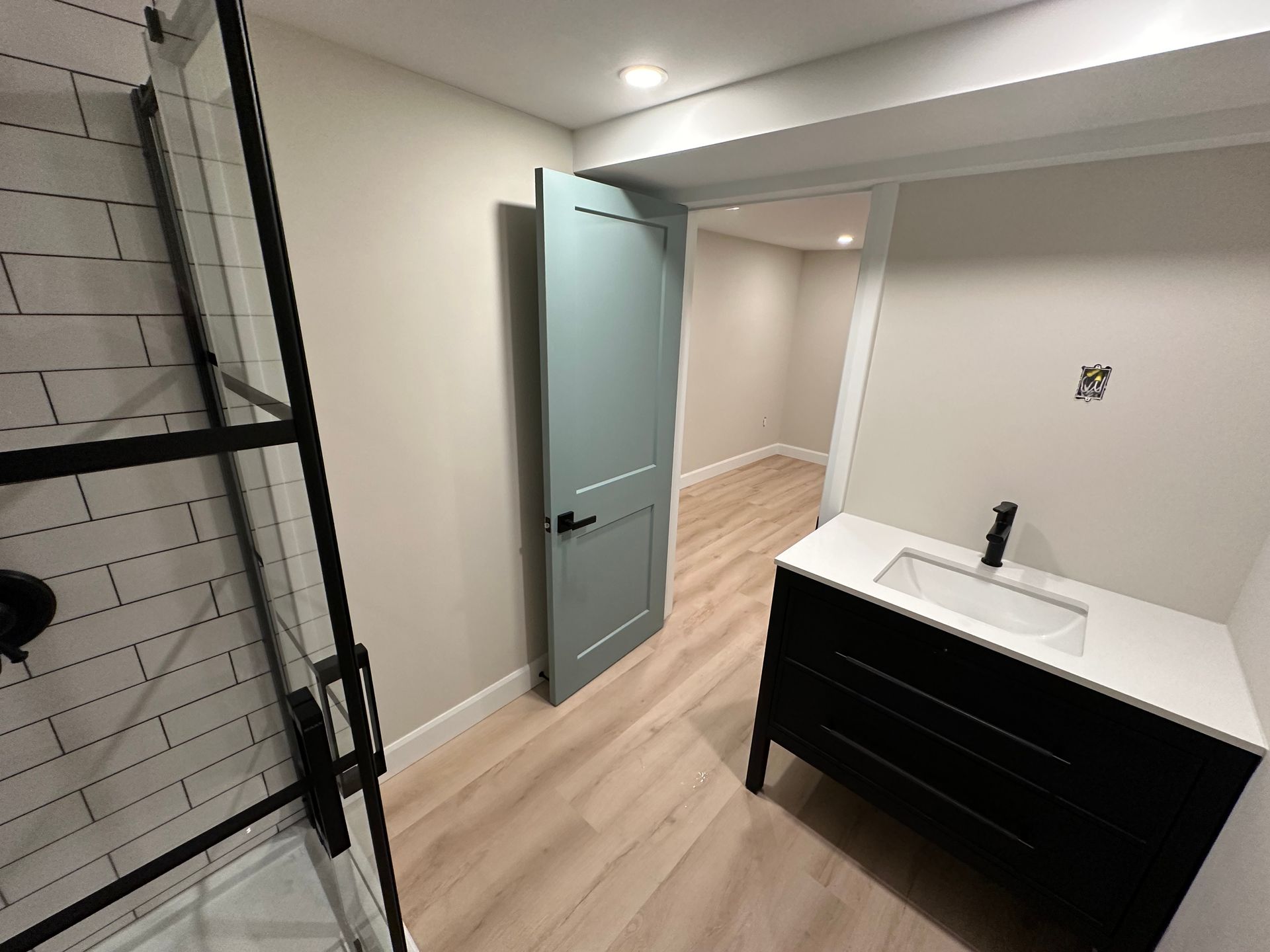 There is a bathroom with a sink and a shower.