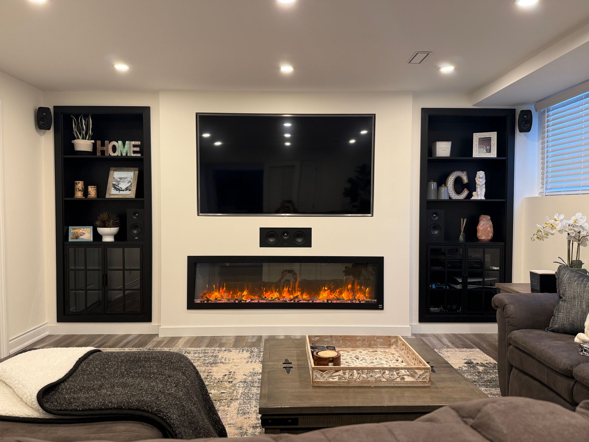 A living room with a fireplace and a flat screen tv.