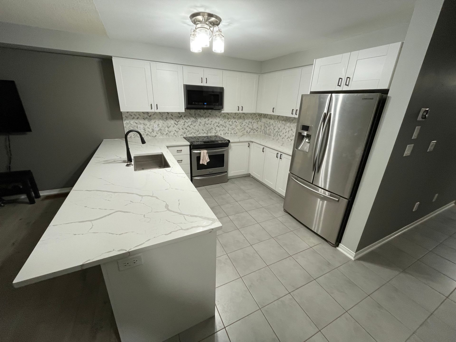 A kitchen with stainless steel appliances and white cabinets