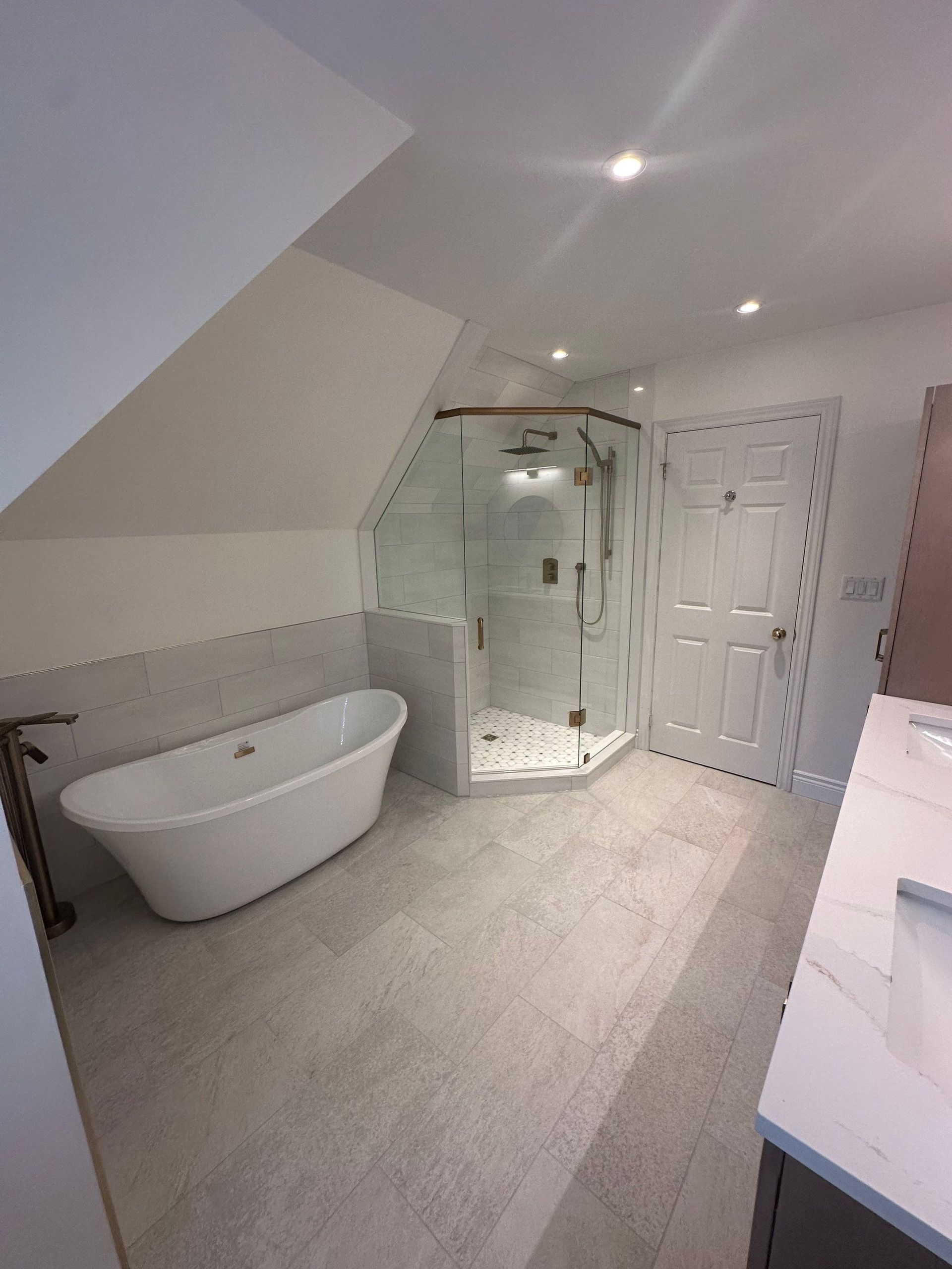 A bathroom with a bathtub and a walk in shower.