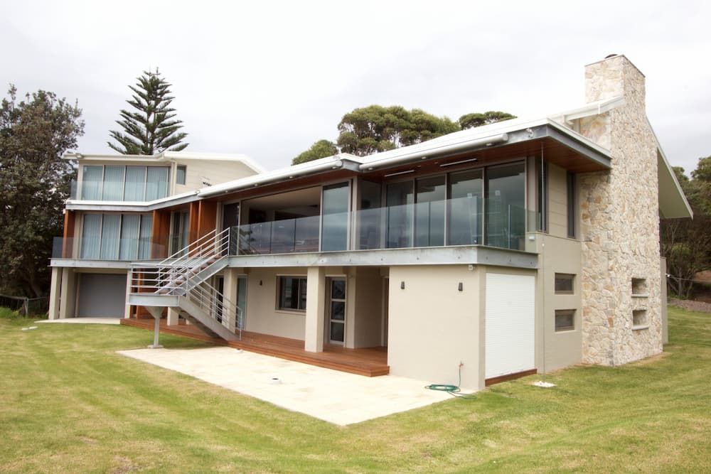 A Large House With A Stone Chimney And A Balcony - Previous Projects in South Nowra, NSW