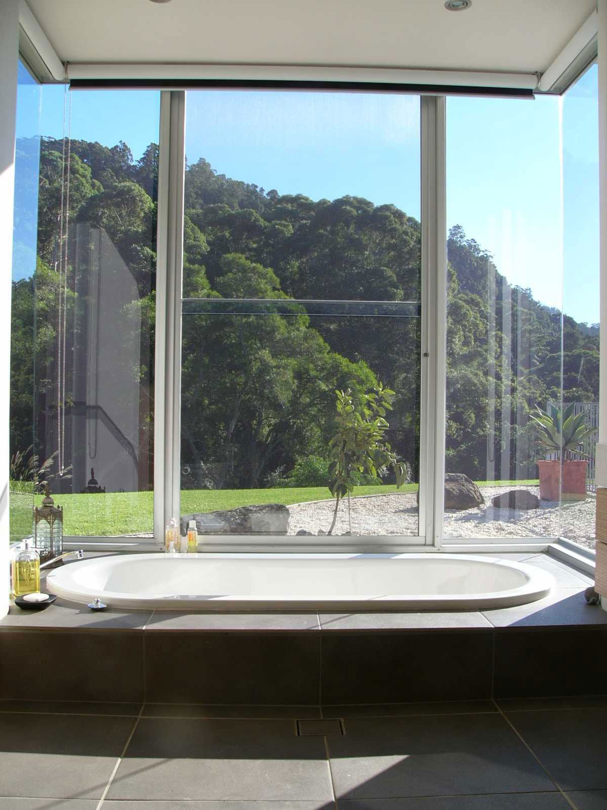 A Bath Tub Area with a Nice View in a Glass Window — Glass Windows & Doors in Shoalhaven, NSW