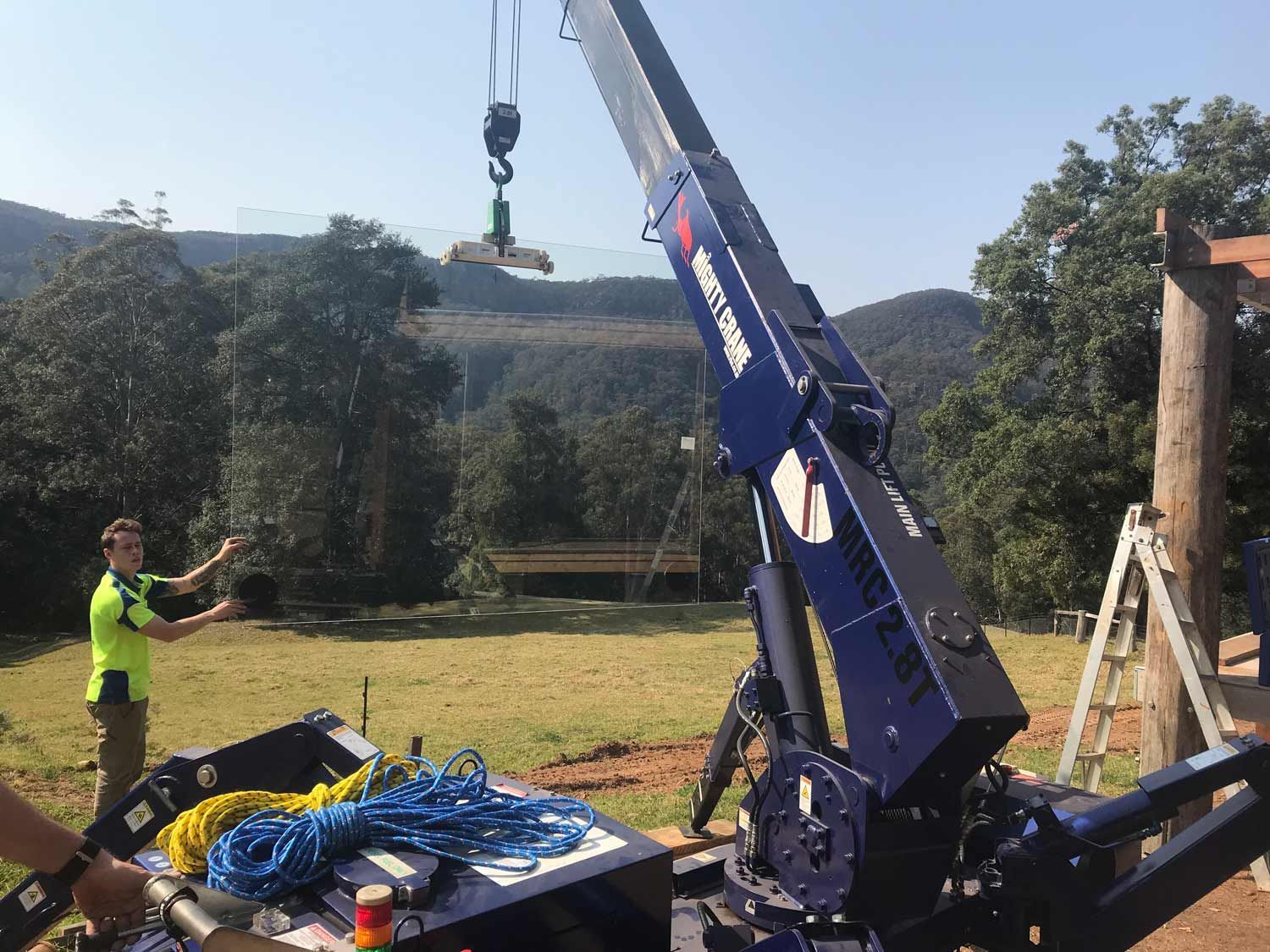 A Blue Crane Holding A Glass — Glass Windows & Doors in Shoalhaven, NSW