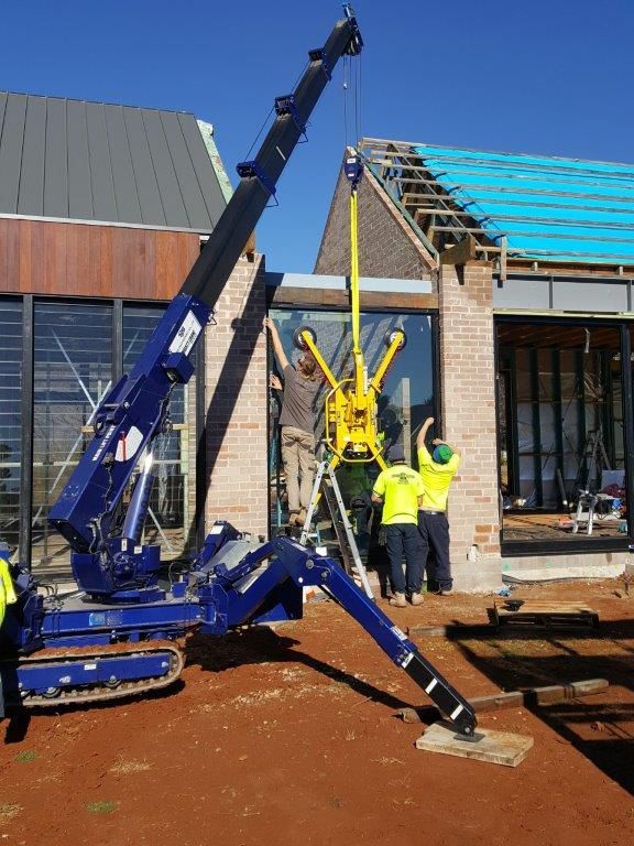 A Truck Installing Glass Wall in a House — Glass Windows & Doors in Shoalhaven, NSW