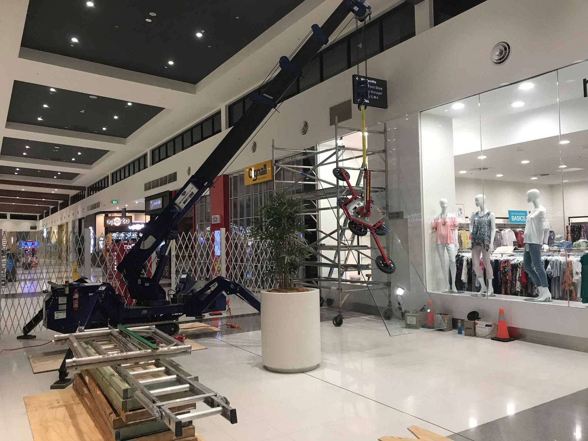 Installing Glass Window in a Mall Boutique — Glass Windows & Doors in Nowra, NSW