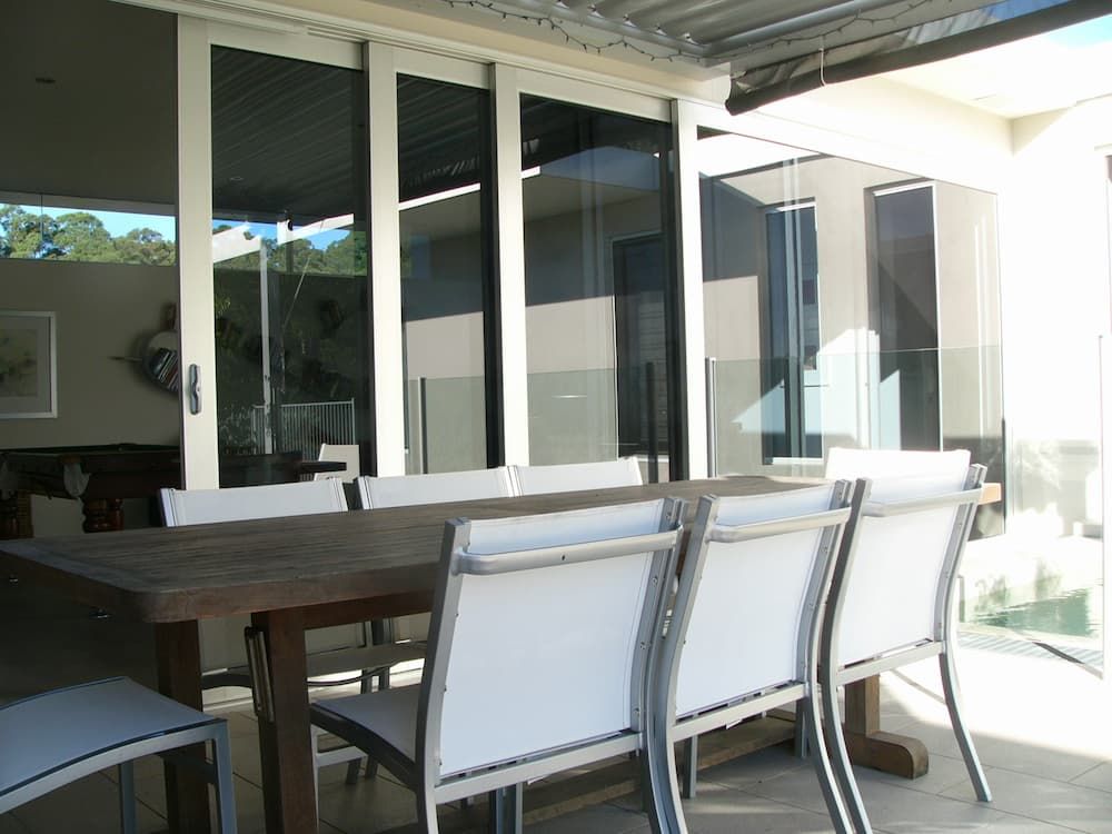 Table Made Of Wood Is Set Beneath A Metal Roof - Previous Projects in South Nowra, NSW